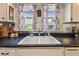 The kitchen area featuring a double bowl sink and a window view at 2505 Amherst Ave, Orlando, FL 32804