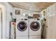 Well-lit laundry room with stacked washer/dryer units and water heater; ample storage space at 2505 Amherst Ave, Orlando, FL 32804