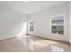 Bright, airy bedroom with tile floors and natural light from two windows at 2506 Aster Cove Ln, Kissimmee, FL 34758