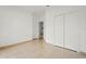 Neutral bedroom with white walls, tile flooring, and a double closet at 2506 Aster Cove Ln, Kissimmee, FL 34758