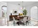 Formal dining room features a wooden table set for four, stylish decor, and an ornate chandelier at 2506 Aster Cove Ln, Kissimmee, FL 34758
