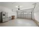 Spacious two-car garage with high ceilings, a refrigerator, and an automatic door opener at 2506 Aster Cove Ln, Kissimmee, FL 34758