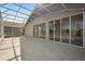 The screened lanai features a concrete floor, a privacy wall and sliding glass doors to the interior at 2506 Aster Cove Ln, Kissimmee, FL 34758