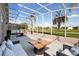 Outdoor furniture sits in the screened-in lanai of this home at 2506 Aster Cove Ln, Kissimmee, FL 34758
