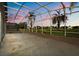 A lanai view at sunset with palm trees and single-Gathering houses at 2506 Aster Cove Ln, Kissimmee, FL 34758