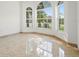 Bright living room featuring three arched windows showcasing the outdoor greenery at 2506 Aster Cove Ln, Kissimmee, FL 34758