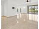 Spacious living room with tile floors, neutral walls, a ceiling fan, and sliding glass doors at 2506 Aster Cove Ln, Kissimmee, FL 34758