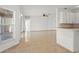 Open-concept living room with tile flooring flowing into the adjacent kitchen area at 2506 Aster Cove Ln, Kissimmee, FL 34758