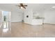 Spacious living room with tile flooring leading to an open kitchen area at 2506 Aster Cove Ln, Kissimmee, FL 34758