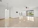Bright and airy living space features tile floors, an ornate light fixture, and sliding glass doors at 2506 Aster Cove Ln, Kissimmee, FL 34758