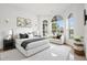 Serene bedroom with ample natural light from large arched windows and comfortable seating at 2506 Aster Cove Ln, Kissimmee, FL 34758