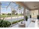 Stylish screened patio with comfortable seating, plants, and views of the well-kept lawn at 2506 Aster Cove Ln, Kissimmee, FL 34758