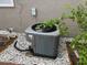 Outdoor AC unit surrounded by white gravel and greenery, providing efficient climate control for the home at 2514 Dovetail Dr, Ocoee, FL 34761
