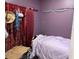 Small bedroom featuring purple walls and a bed with patterned bedding at 2514 Dovetail Dr, Ocoee, FL 34761