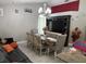 Bright and inviting dining and living area with a cozy leather couch, decorative chandelier and an open-concept feel at 2514 Dovetail Dr, Ocoee, FL 34761