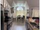 Modern kitchen design featuring stainless steel appliances, granite countertops, a breakfast nook and open-concept floor plan at 2514 Dovetail Dr, Ocoee, FL 34761
