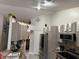 Charming gray kitchen featuring updated appliances, modern backsplash, granite countertops, and an abundance of cabinet storage at 2514 Dovetail Dr, Ocoee, FL 34761