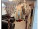 A view looking in to the living room, showcasing tile flooring, a leather couch, beaded doorway and a red rug at 2514 Dovetail Dr, Ocoee, FL 34761