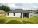 Well-maintained backyard featuring a screened-in patio, lush lawn and gray privacy fence at 3422 Heath Dr, Deltona, FL 32725