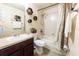 Cozy bathroom with shower and tub combination, dark wood cabinets, and decorative accents at 3422 Heath Dr, Deltona, FL 32725