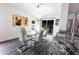 Bright dining room boasts a glass table and modern mirror wall art at 3422 Heath Dr, Deltona, FL 32725