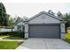 Well-maintained home features a two-car garage, gray exterior, and tidy landscaping at 3422 Heath Dr, Deltona, FL 32725