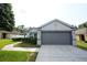 Attractive gray home with a two-car garage, neat landscaping, and inviting curb appeal at 3422 Heath Dr, Deltona, FL 32725