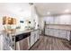 Bright kitchen with stainless steel appliances, gray cabinets, granite counters, and a dining area at 3422 Heath Dr, Deltona, FL 32725