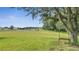 Expansive backyard with lush green grass, pond, and a charming tree swing offering a serene outdoor retreat at 4394 Devon Ct, Kissimmee, FL 34746