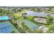 Community basketball court is surrounded by lush landscaping with tennis courts and a pool in the distance at 4394 Devon Ct, Kissimmee, FL 34746