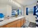Bright bathroom featuring double sinks, stylish fixtures, and blue accents at 4394 Devon Ct, Kissimmee, FL 34746