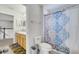 Well-lit bathroom featuring a toilet and a patterned shower curtain at 4394 Devon Ct, Kissimmee, FL 34746