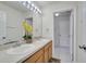Bathroom showcasing double sinks with a view into the toilet and shower room at 4394 Devon Ct, Kissimmee, FL 34746