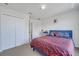 Bedroom with double closet and red patterned bedspread at 4394 Devon Ct, Kissimmee, FL 34746