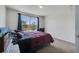 Bedroom with view of trees through window and red patterned bedspread at 4394 Devon Ct, Kissimmee, FL 34746