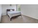 Bright bedroom featuring neutral carpet, a wooden bed frame, and a sunny window at 4394 Devon Ct, Kissimmee, FL 34746