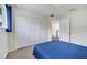 Bright bedroom has a large closet, neutral carpet, and a bed with blue bedding at 4394 Devon Ct, Kissimmee, FL 34746