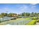 Community basketball and tennis courts, with a pool and clubhouse in the background, offer outdoor activities at 4394 Devon Ct, Kissimmee, FL 34746