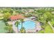 Aerial view of the community pool, splash pad, playground, tennis courts, and clubhouse at 4394 Devon Ct, Kissimmee, FL 34746