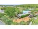 An aerial view of a community pool and playground surrounded by lush landscaping at 4394 Devon Ct, Kissimmee, FL 34746