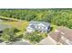 An aerial view of a two story home in manicured neighborhood with mature trees and landscaping at 4394 Devon Ct, Kissimmee, FL 34746