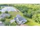 Aerial view highlighting the home's location near a lake and surrounded by lush greenery and landscaping at 4394 Devon Ct, Kissimmee, FL 34746