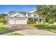 Charming two-story home featuring a three-car garage and well-maintained landscaping at 4394 Devon Ct, Kissimmee, FL 34746