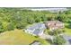 Aerial view of the home with manicured lawn in a residential community with mature tree coverage at 4394 Devon Ct, Kissimmee, FL 34746