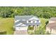 Aerial view of a well-maintained two-story home with a three-car garage and beautifully landscaped front yard at 4394 Devon Ct, Kissimmee, FL 34746