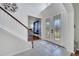 Grand foyer featuring a staircase, stylish tile flooring, and an elegant front door at 4394 Devon Ct, Kissimmee, FL 34746