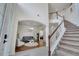 Spacious foyer with staircase, leading to a living room with stylish furniture and decor at 4394 Devon Ct, Kissimmee, FL 34746
