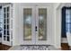 Elegant front door with decorative glass panels leading to the bright and airy foyer at 4394 Devon Ct, Kissimmee, FL 34746