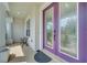 Stylish front door with decorative glass accents, covered porch, and seating area at 4394 Devon Ct, Kissimmee, FL 34746