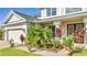 Charming home exterior with a well-manicured lawn, beautiful landscaping, and attached two-car garage at 4394 Devon Ct, Kissimmee, FL 34746
